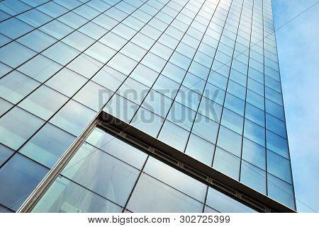 Surface Of Glass Building With The Reflection Of Clouds