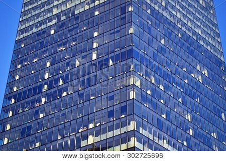 New Office Building In Business Center. Wall Made Of Steel And Glass With Blue Sky.