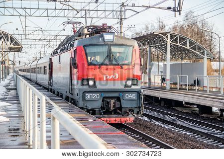 Russian Train. Locomotive With Cars. Passenger Train. . Russia Metallostroy March 8, 2019