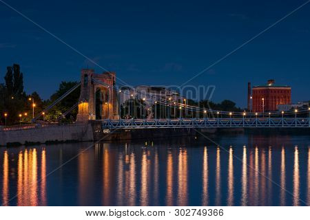 Grunwaldzki Bridge in Wroclaw, Poland with reflection in Odra River. Beautiful Night in city skyline, Breslau, 2019.