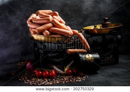 Large Pile Of Delicious Long Thin Wieners On Antiquarian Scales