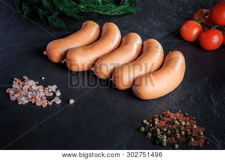 Top View Row Of Short Thick Sausages With Dill And Tomatoes