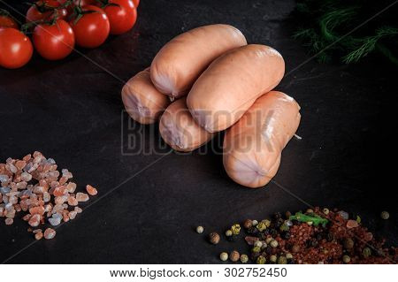 Small Pile Of Thick Short Sausages With Dill And Tomatoes