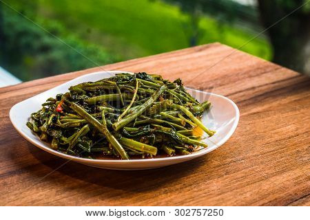 Stir Fry Sambal Chilli Kang Kong Vegetable Served In A White Porcelain Dish
