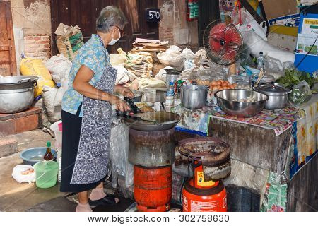 Bangkok, Thailand - March 23rd 2015: Woman Cooking, Steet Kitchen, Chinatown, Bangkok, Thailand