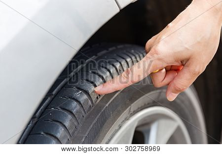 Close Up Of Woman Hand Poin To Nail Stab At The Tire