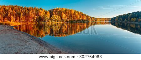 Silence At The Forest Lake At Sunset, With Reflection Of Sky And Forest On A Water Smooth Surface, A