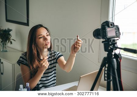 Girl Videoblogger Or Beauty Blogger Records Video For Subscribers. She Shows Lipstick And Tells How 