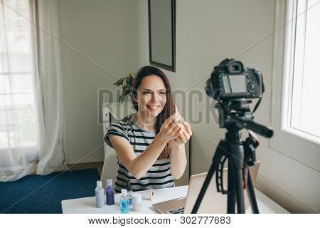Girl Videoblogger Or Beauty Blogger Records Video For Subscribers. She Shows Lipstick And Tells How 