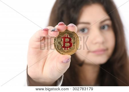 Pretty Girl Holding In Front Of Her New Gilden Cryptocurrency Bitcoin In Hands On White Background. 