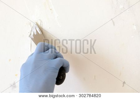 Hand With Putty Knife Repair Wall, Hand With A Spatula, Spatula With Spackle Paste Structure, Proces