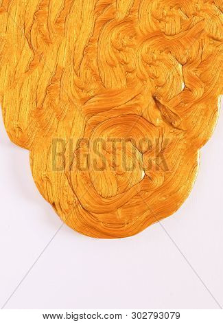 Golden Plasticine Soft Stretchable Texture On White Background. Anti-stress Toy For Kids Activities,
