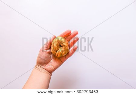 Golden Plasticine In A Hand. Soft Stretchable Texture. Anti-stress Toy For Kids Activities, Handmade