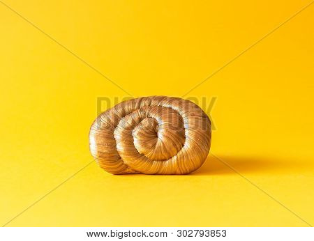 Golden Plasticine Soft Stretchable Texture On Yellow Background. Anti-stress Toy For Kids Activities