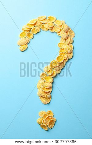 Yellow Flakes In The Shape Of A Question Mark On A Blue Background. How To Choose Cereal For Breakfa