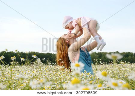 Young Mother With Her Daughter In Nature