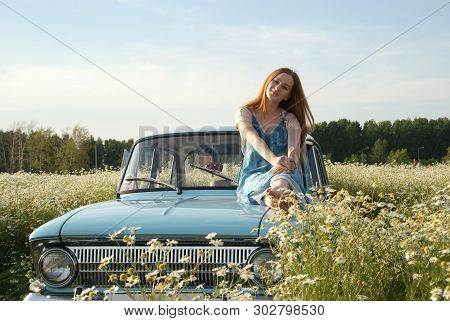 Beautiful Girl Sitting On A Retro Car