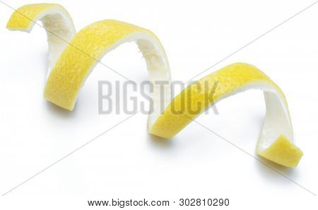 Lemon peel or lemon twist on white background. Close-up.