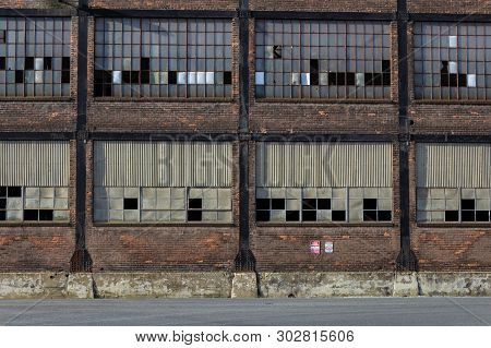 Straight On View Of Old Steel Mill Warehouse Industrial Site, Broken Windows, Horizontal Aspect
