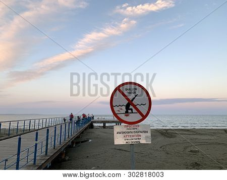 Larnaka, Cyprus - May 11, 2019: Warning Sign On The Prohibition Of Jumping Into The Water On The Bea