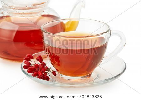 Healthy tea with barberries in glass cup on on a white background.
