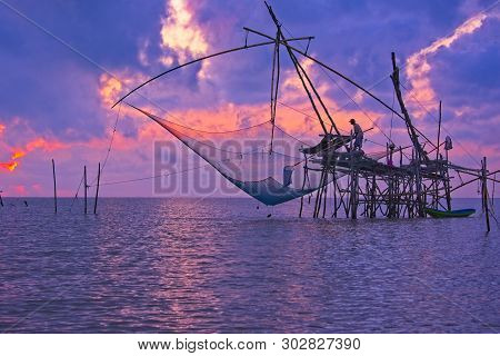 The Fisherman Is Going To Scoop His Fishes At The Bottom Of Big Fish Trap. Phatthalung, Thailand.