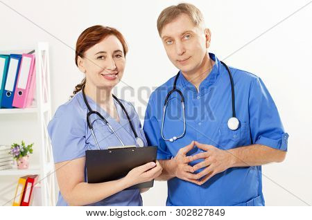Two Doctors Standing In Medical Office Clinic, Doctor And Nurse, Medical Insurance
