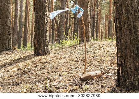 Unexploded Rusty Bomb From The War Is Marked Label In The Form Of Sticks And Flag Of Garbage