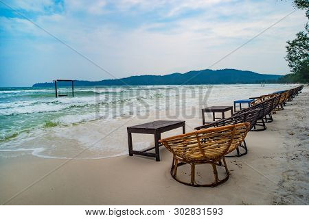 Wooden Cafe Table And Chairs On A Tropical Beach With Blue Sea On Background. Island Koh Rong Samloe
