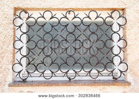 Old House Window Style With Curved Steel, Decorative Iron Gratings With Decorative Details. Abstract