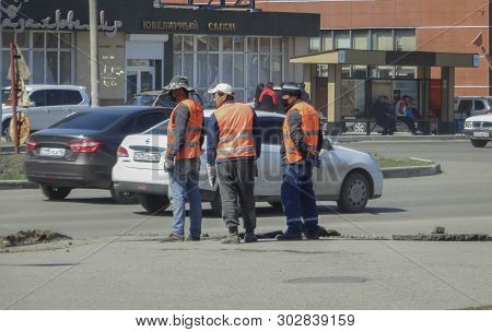 Kazakhstan, Ust-kamengorsk, April 23, 2019: Road Workers On The Street. Construction Workers. Citysc