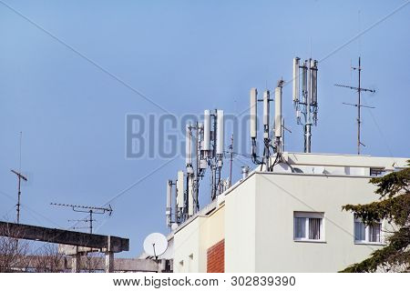 Telecommunication Base Stations Network Repeaters On The Roof Of The Building. The Cellular Communic