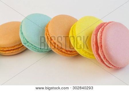 French Pastry Cookies Cupcake Macarons Close-up. Macaroons Multi-color On A White Background, Yellow