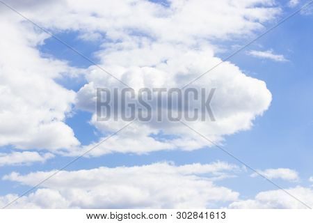 Big Cloud. Bushy Natural Clouds Against A Clear Clean Blue Sky. Sky On A Clear Sunny Day