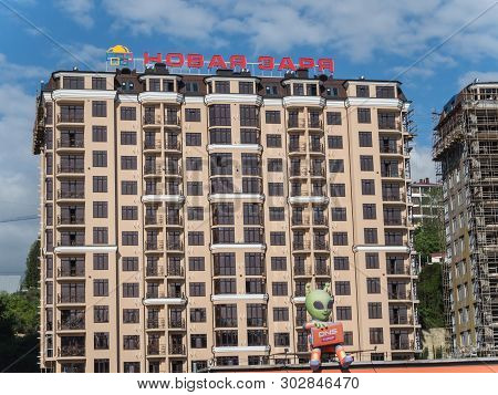 A High-rise Building Under Construction With An Inscription On The Roof Of Novaya Zarya In Sochi Rus