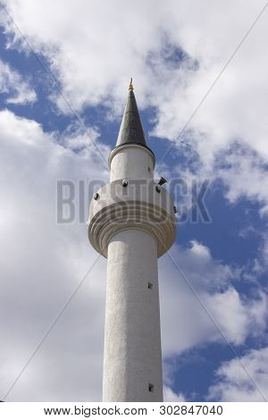Minaret Of A Muslim Mosque On The Background Of The Cloudy Sky. One Minaret Aspiring To Heaven, A Re