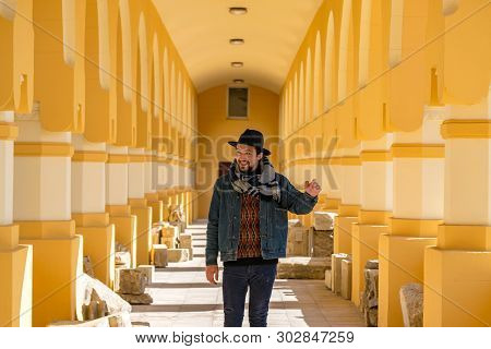 Portrait Of A Stylish Handsome Young Man With A Scarf Outdoors.  A Happy Man Wearing A Scarf, Hat An