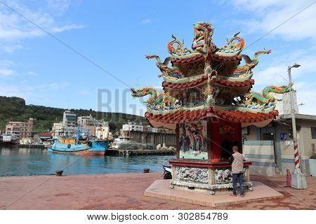 Yehliu, Taiwan - November 24, 2018: Person Visits A Shrine Next To The Harbor Of Yehliu, Taiwan. Yeh