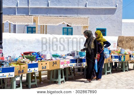 Djerba, Tunisia- April 16: Women Make Their Purchases Of A Variety Of  Products In Market In Houmt E