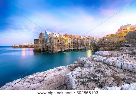 Sunset At Cala Paura Gulf With Bastione Di Santo Stefano In Village On The Rocks Polignano A Mare, A