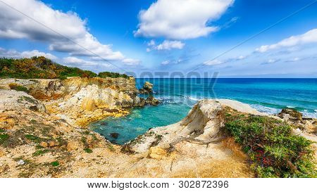 Picturesque Seascape With White Rocky Cliffs, Sea Bay, Islets And Faraglioni Near By Conca Specchiul