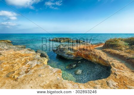 Picturesque Seascape With White Rocky Cliffs, Sea Bay, Islets And Faraglioni Near By Conca Specchiul