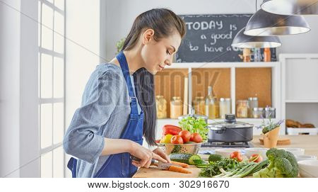 A Young Woman Prepares Food In The Kitchen. Healthy Food - Vegetable Salad. Diet. The Concept Of Die