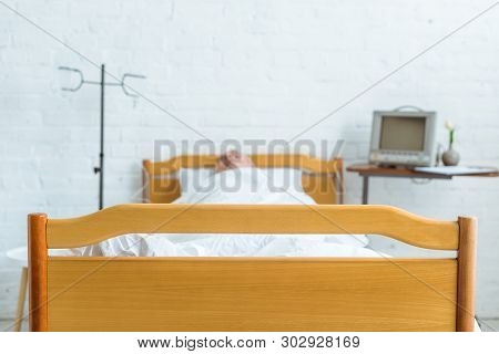 Selective Focus Of Senior Patient In Coma In Hospital