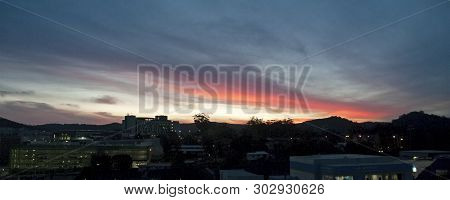 A Eye Catching Dramatic Pink-magenta Cirrostratus Cloud, Sunset Landscape With The Horizon In Silhou