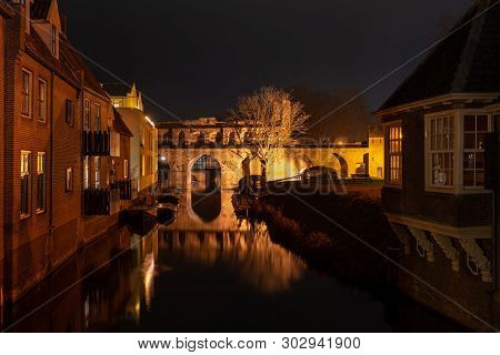 Historic Water Gate Of The River Berkel In Zutphen At Night Seen From The Westside
