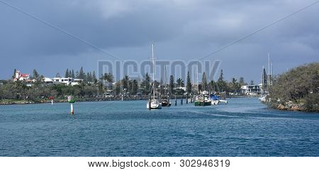 Moored Yachts In The Mooloolaba Marina On Mooloolah River On A Sunny But Cloudy Day. Rock Wall Along
