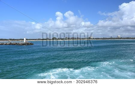 People Relaxing On Rock Wall Mooloolaba (sunshine Coast, Queensland, Australia) On A Sunny But Cloud