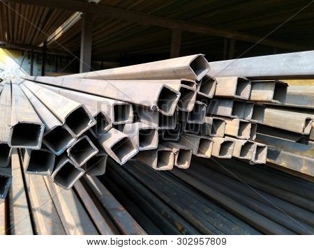 A Picture Of Stainless Steel Pipes With Dark Background