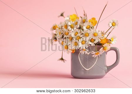 Bouquet Of Field Daisies In A Mug On A Pink Background. Happy Birthday Or Holiday Concept.